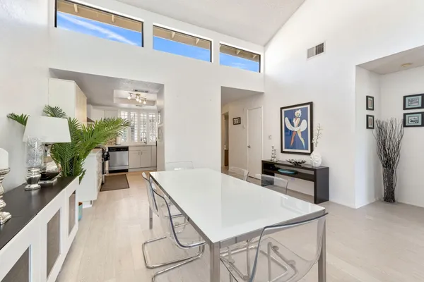 a living room with furniture a flat screen tv and a table