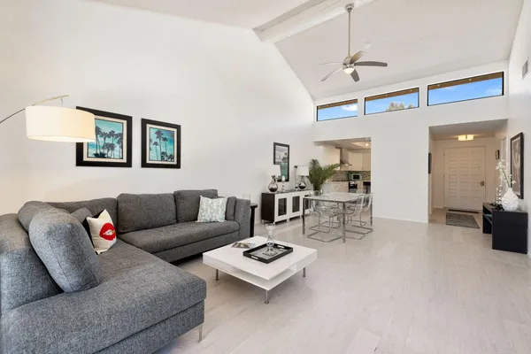 a living room with furniture and a chandelier