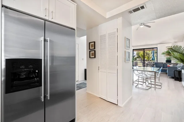a view of a hallway with furniture and floor to ceiling window