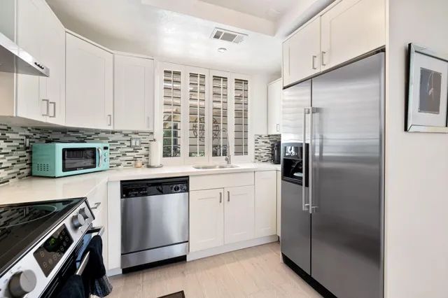a kitchen with a refrigerator stove and sink