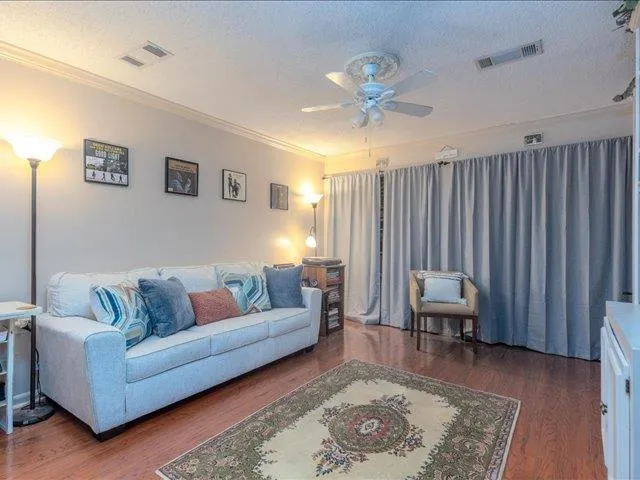 a living room with furniture and a book shelf