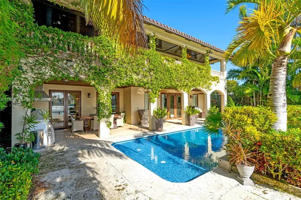 a view of a house with backyard porch and sitting area