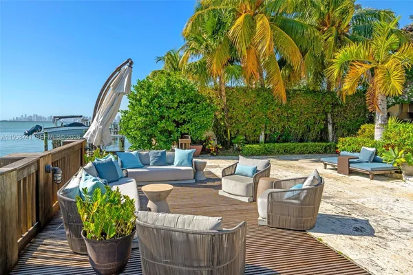 a view of a patio with couches and potted plants