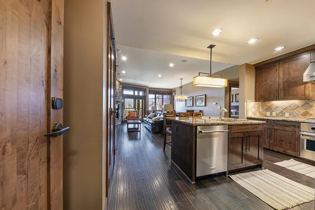 a kitchen with stainless steel appliances granite countertop a stove and a refrigerator