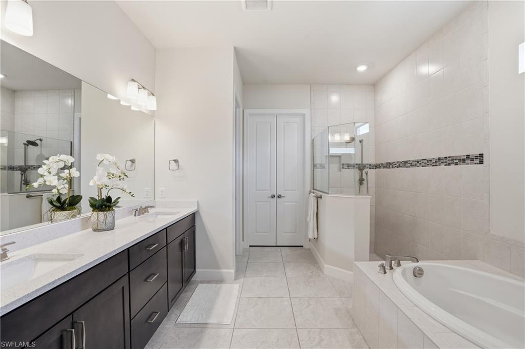 19696 Aqua View Lane Fort Myers, FL 33913 - Photo 18 of 50 a spacious bathroom with a bathtub sink and mirror