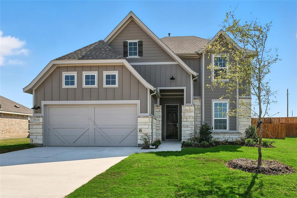 Craftsman-style house with board and batten siding, roof with shingles, concrete driveway, and stone siding