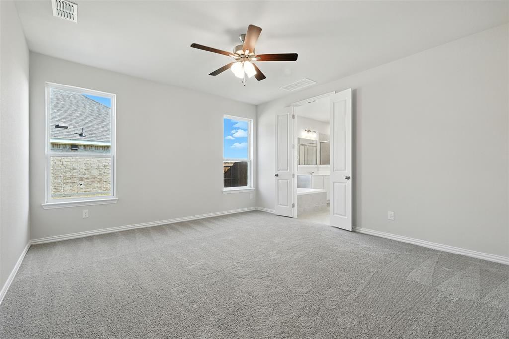 2515 Ridgecrest Lane Sherman, TX 75092 - Photo 14 of 40 Spare room featuring carpet flooring, healthy amount of natural light, and a ceiling fan