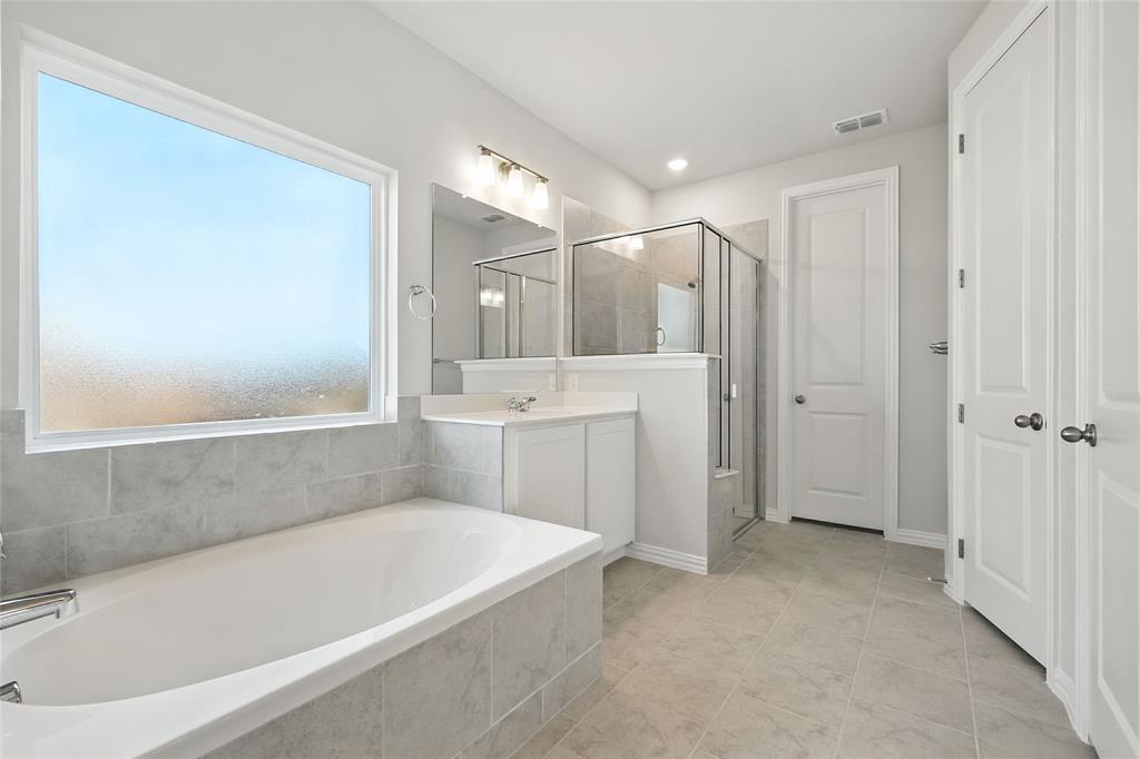 2515 Ridgecrest Lane Sherman, TX 75092 - Photo 17 of 40 Bathroom featuring a garden tub, a shower stall, vanity, and tile patterned flooring