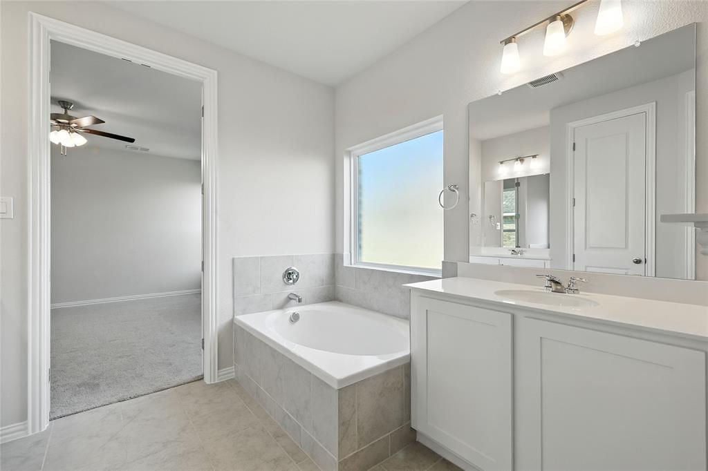 2515 Ridgecrest Lane Sherman, TX 75092 - Photo 18 of 40 Full bath featuring vanity, a garden tub, ceiling fan, and tile patterned flooring