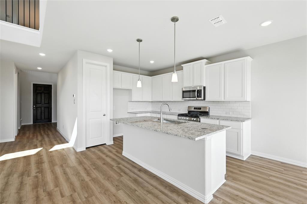 2515 Ridgecrest Lane Sherman, TX 75092 - Photo 2 of 40 Kitchen with decorative backsplash, appliances with stainless steel finishes, light wood-style flooring, and recessed lighting