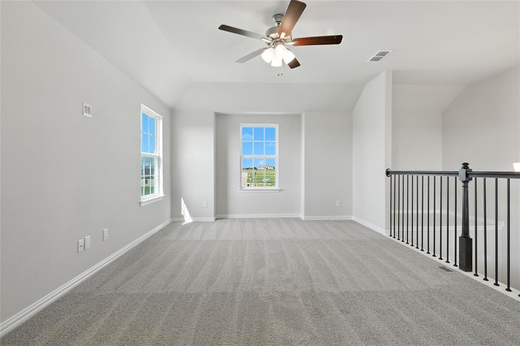2515 Ridgecrest Lane Sherman, TX 75092 - Photo 23 of 40 Spare room with carpet, vaulted ceiling, and a ceiling fan