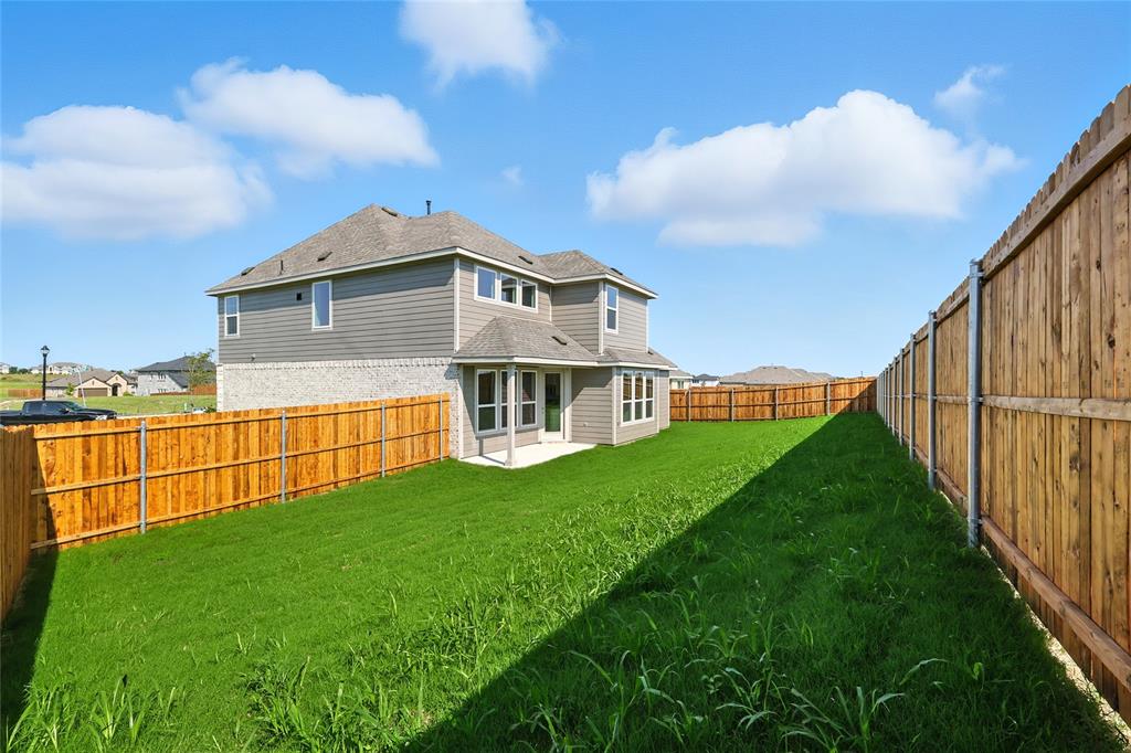 2515 Ridgecrest Lane Sherman, TX 75092 - Photo 29 of 40 Rear view of property featuring a shingled roof, a fenced backyard, and a patio area