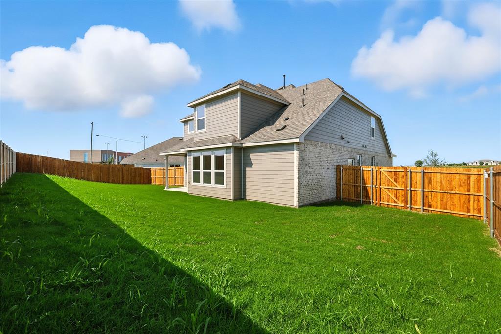2515 Ridgecrest Lane Sherman, TX 75092 - Photo 30 of 40 Back of property featuring a fenced backyard, a shingled roof, and brick siding