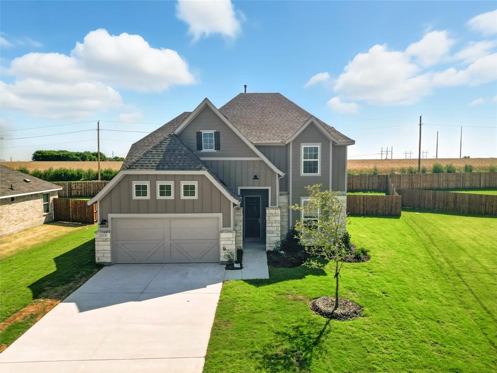 2515 Ridgecrest Lane Sherman, TX 75092 - Photo 32 of 40 View of front facade featuring board and batten siding, roof with shingles, stone siding, concrete driveway, and a garage