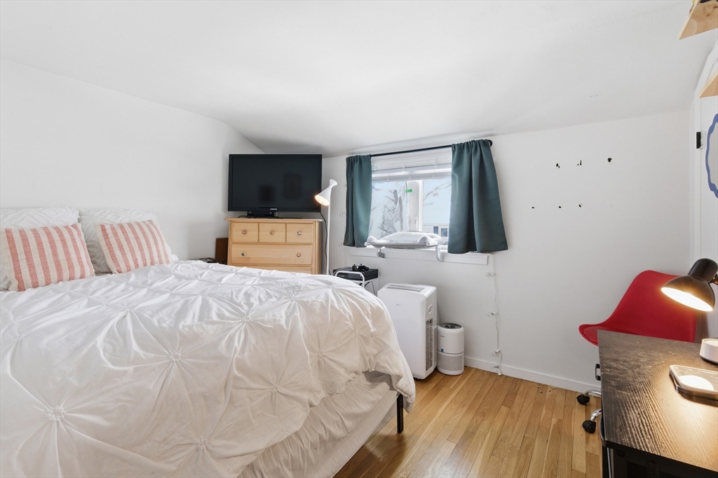 5 Lewis Farm Road, Unit 5 Dedham, MA 02026 - Photo 14 of 18 a bedroom with a bed and a flat screen tv
