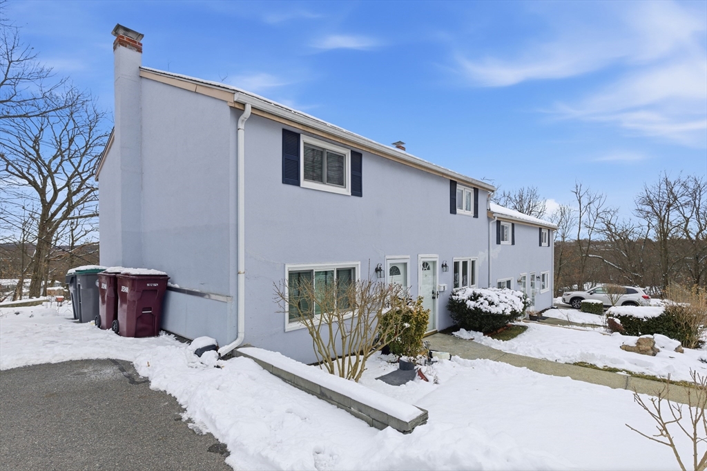 5 Lewis Farm Road, Unit 5 Dedham, MA 02026 - Photo 2 of 18 a view of a patio with a table and chairs