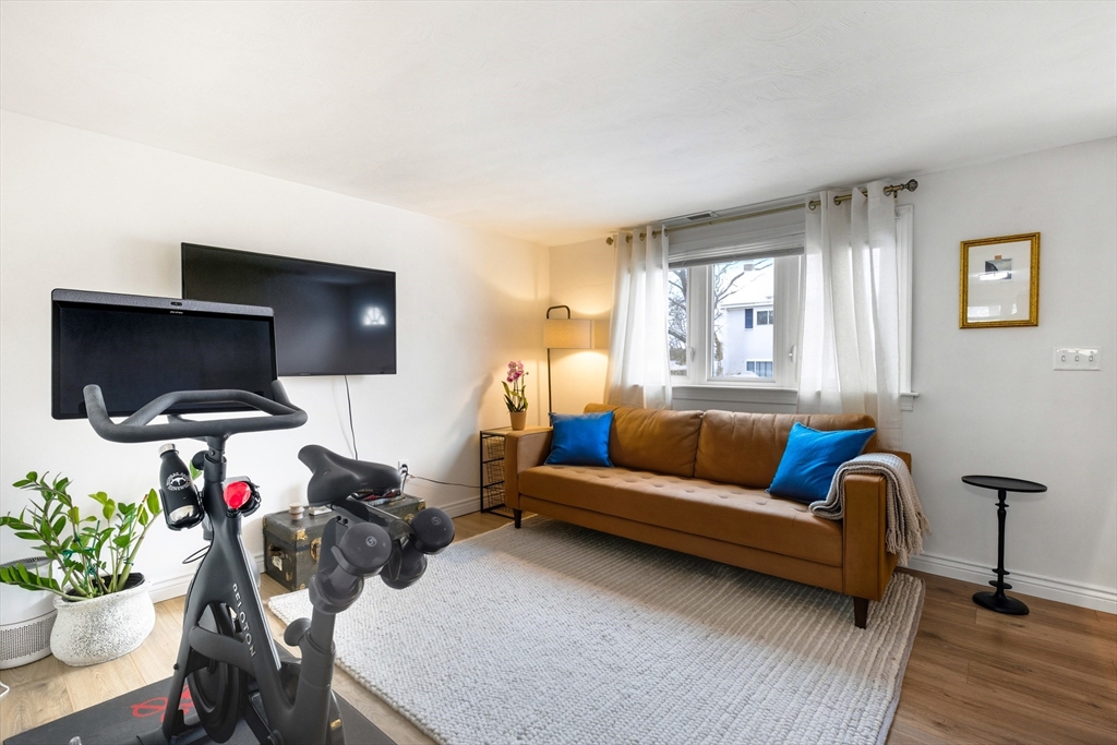 5 Lewis Farm Road, Unit 5 Dedham, MA 02026 - Photo 5 of 18 a living room with furniture and a flat screen tv