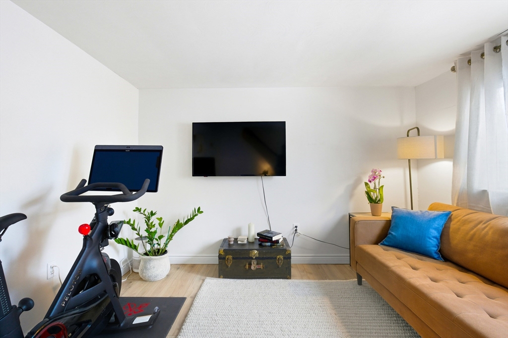 5 Lewis Farm Road, Unit 5 Dedham, MA 02026 - Photo 6 of 18 a living room with furniture and a flat screen tv