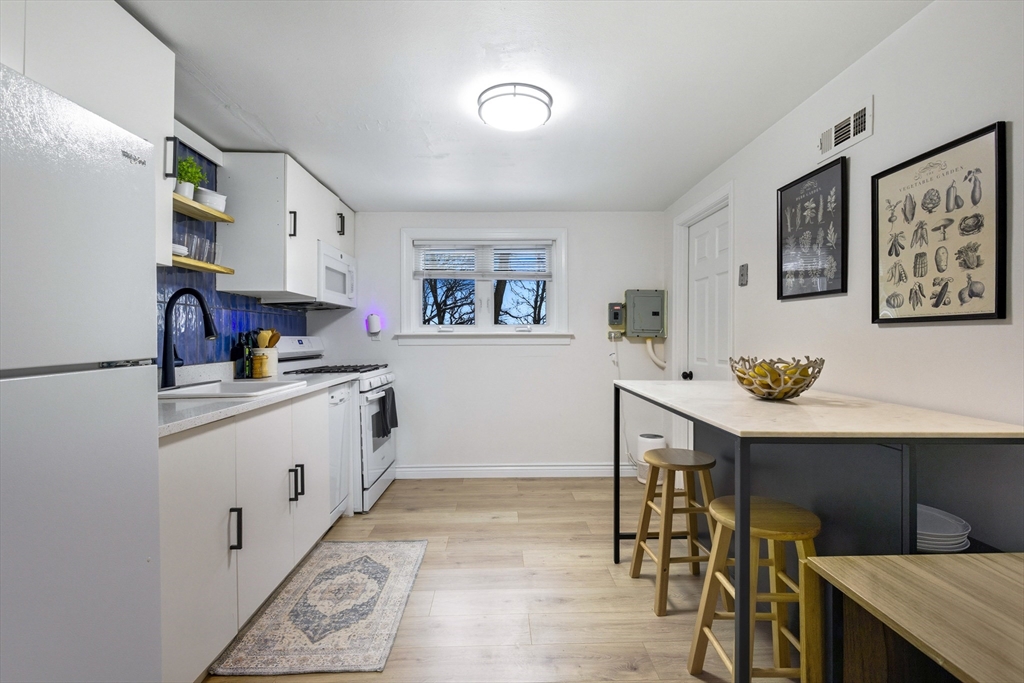 5 Lewis Farm Road, Unit 5 Dedham, MA 02026 - Photo 7 of 18 a kitchen with appliances cabinets and furniture