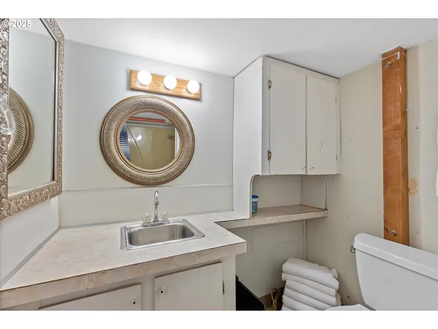 a kitchen with a sink cabinets and a window