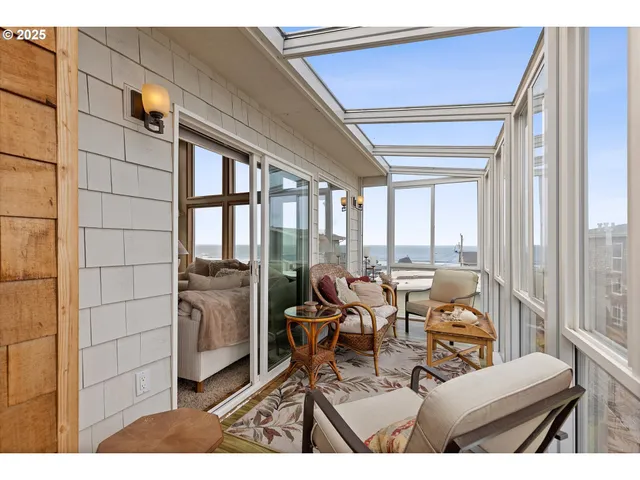 a view of a living room and balcony with furniture