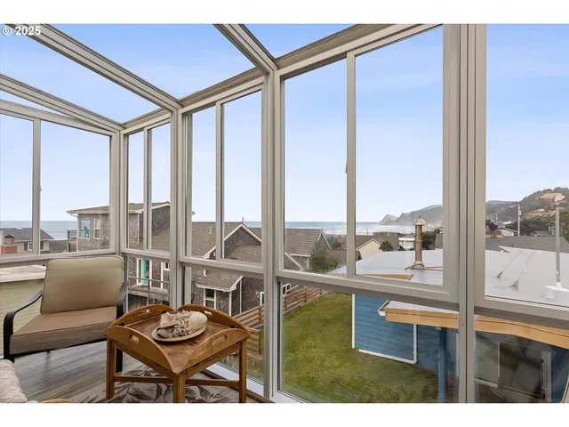 a living room with furniture and a floor to ceiling window