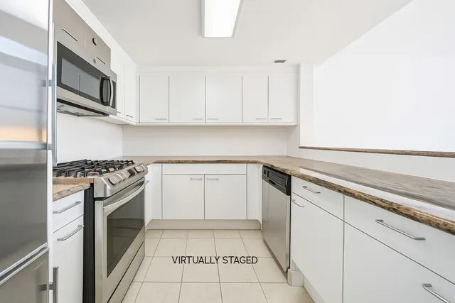 a kitchen with cabinets appliances and a sink