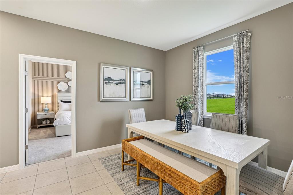 3851 Rising Trail Davenport, FL 33837 - Photo 10 of 39 a view of a dining room with a table and chairs