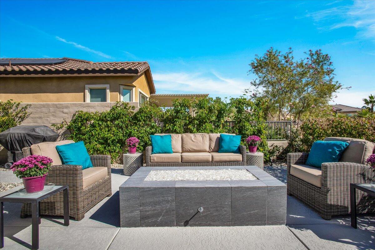74 Barolo Rancho Mirage, CA 92270 - Photo 34 of 56 a view of a patio with couches and a table and chairs with potted plants