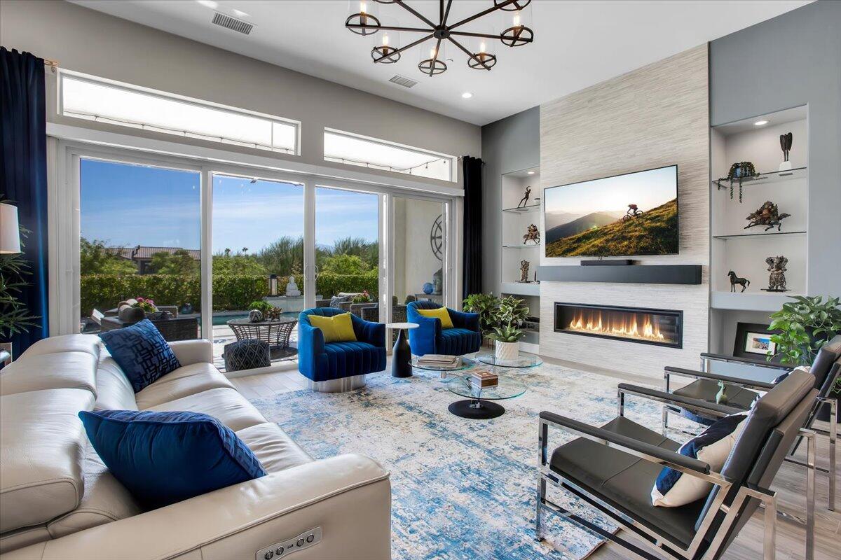 74 Barolo Rancho Mirage, CA 92270 - Photo 9 of 56 a living room with fireplace furniture and a flat screen tv