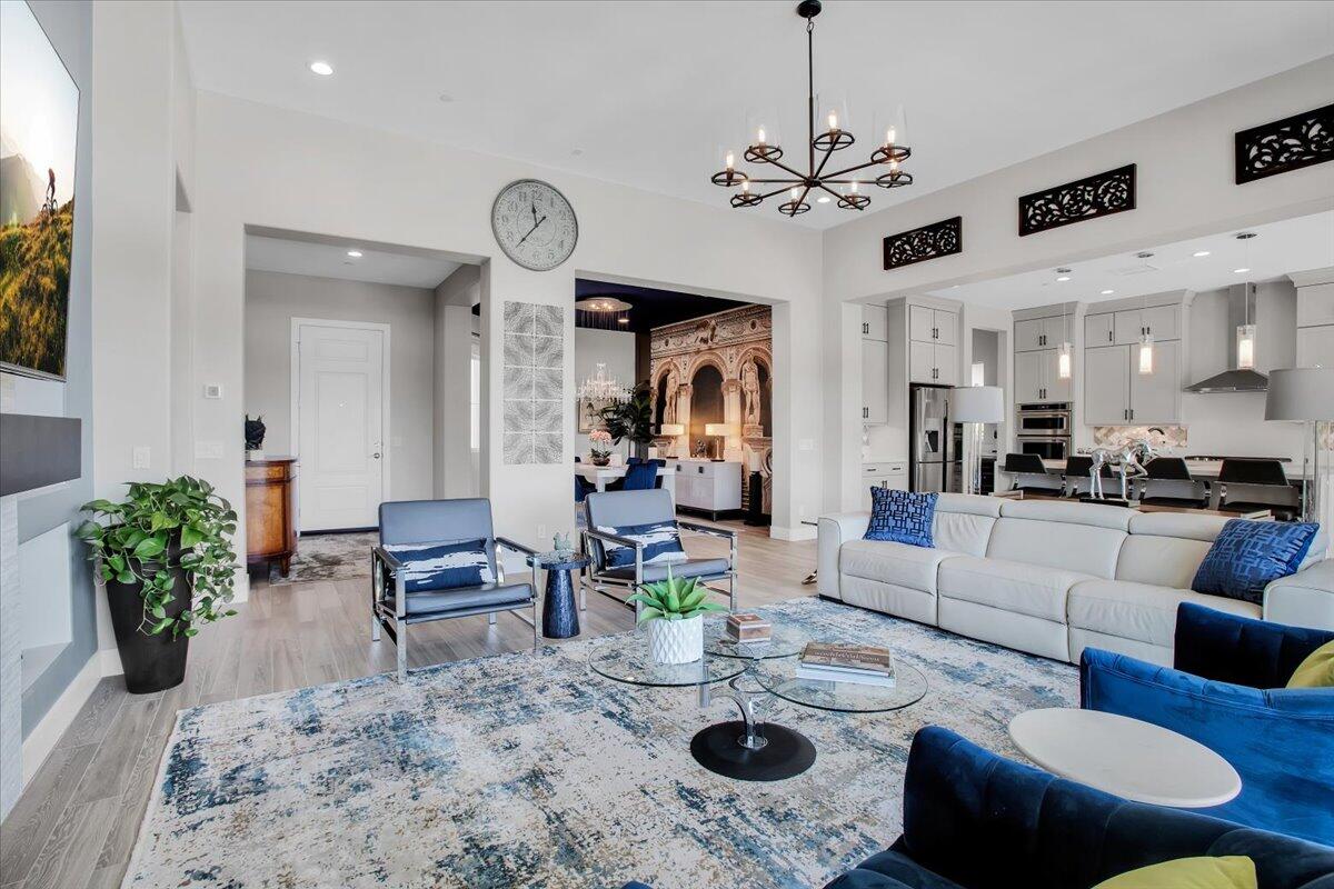 74 Barolo Rancho Mirage, CA 92270 - Photo 10 of 56 a living room with furniture a fireplace and a chandelier