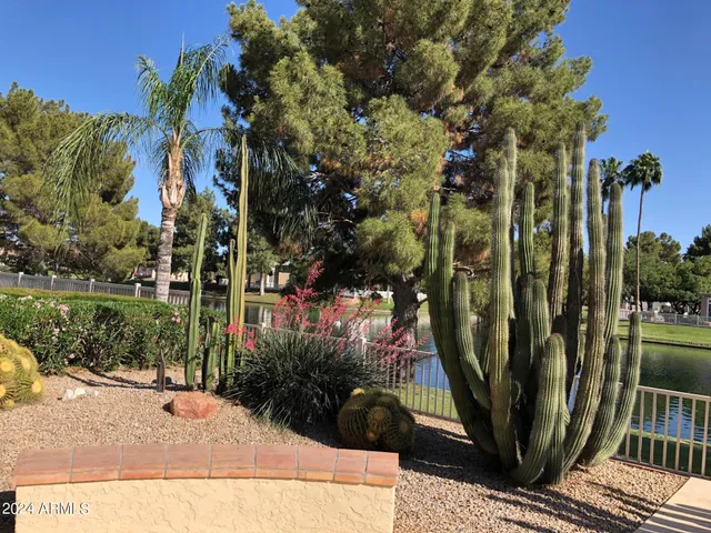 a bathroom with a sink a toilet a mirror and shower