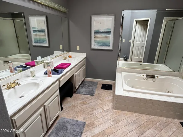 a bedroom with bed and a flat tv screen on the dresser