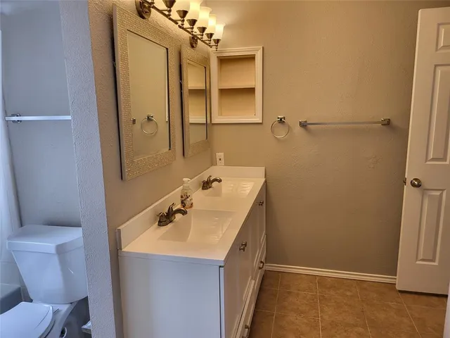 a bathroom with a toilet and a bath tub