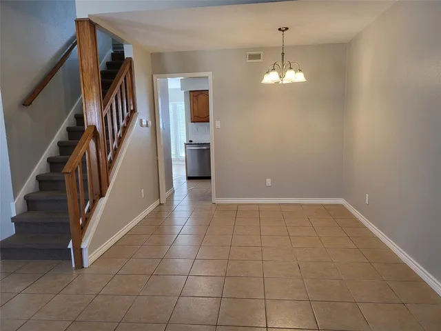 a kitchen with granite countertop a refrigerator stove and sink