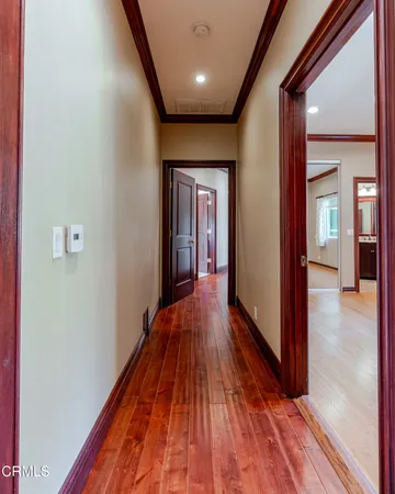 a view of hallway with wooden floor