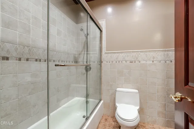 a bathroom with a toilet and shower