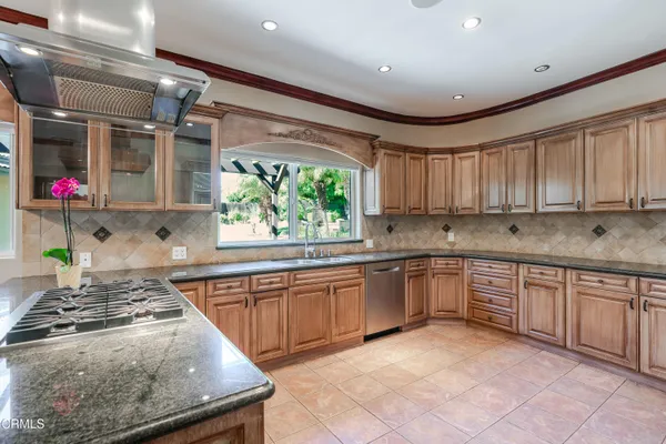 a kitchen with stainless steel appliances granite countertop sink stove and cabinets