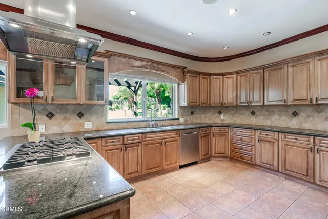 a kitchen with stainless steel appliances granite countertop sink stove and cabinets