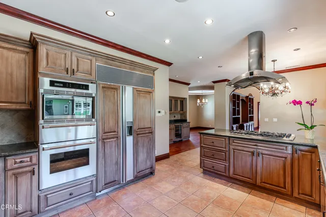 a kitchen with stainless steel appliances a sink and cabinets
