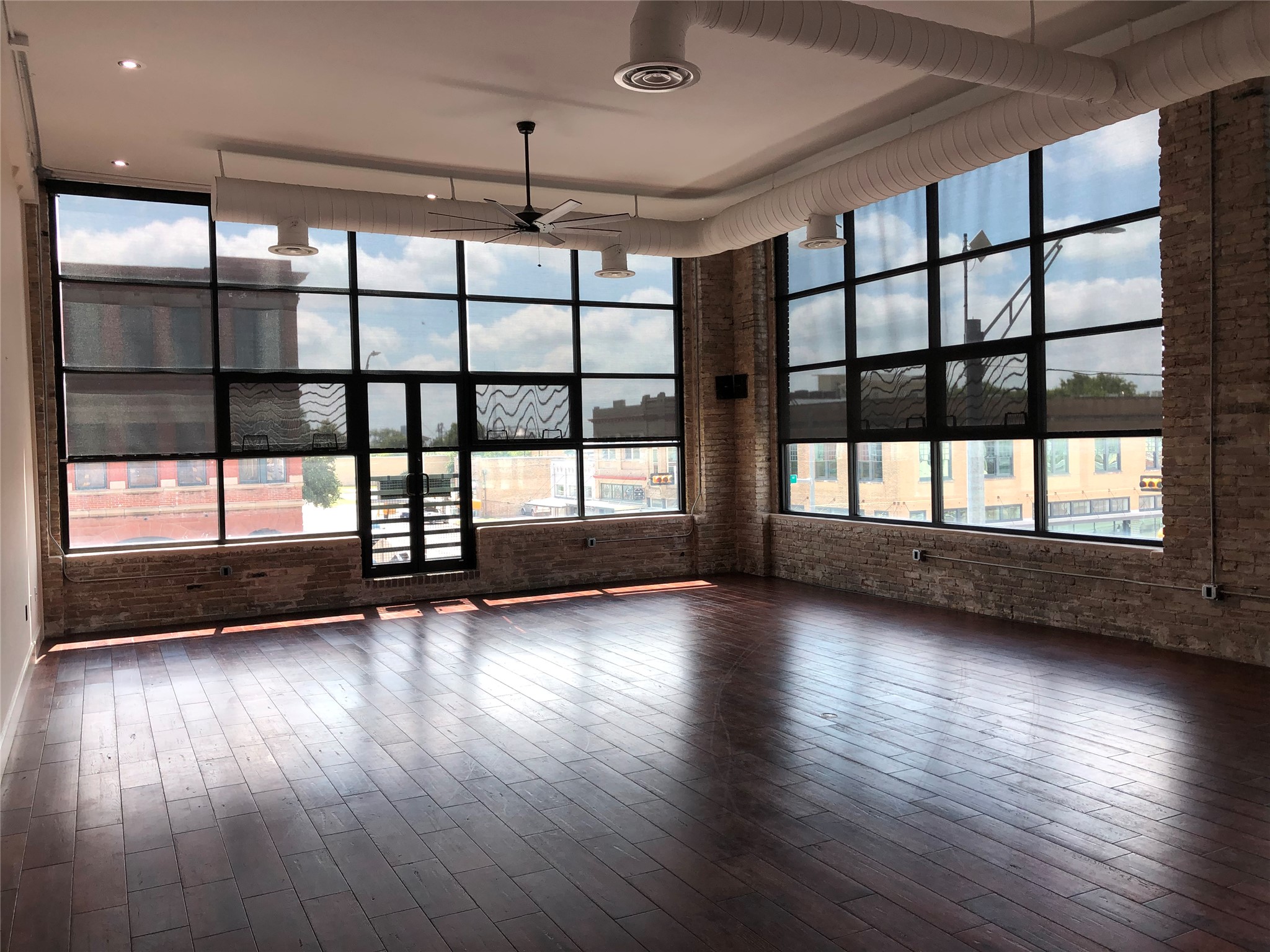110 West 2nd Street, Unit LOFT B Taylor, TX 76574 - Photo 1 of 11 a view of an empty room wooden floor and a window
