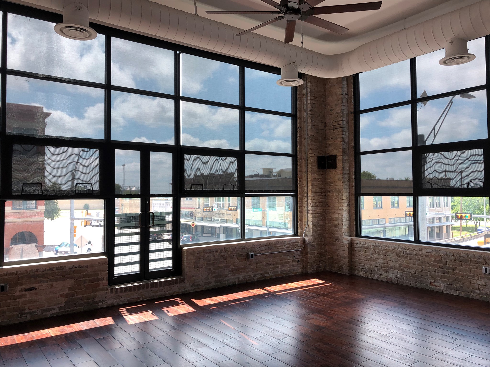 110 West 2nd Street, Unit LOFT B Taylor, TX 76574 - Photo 2 of 11 a view of an empty room with wooden floor and a window