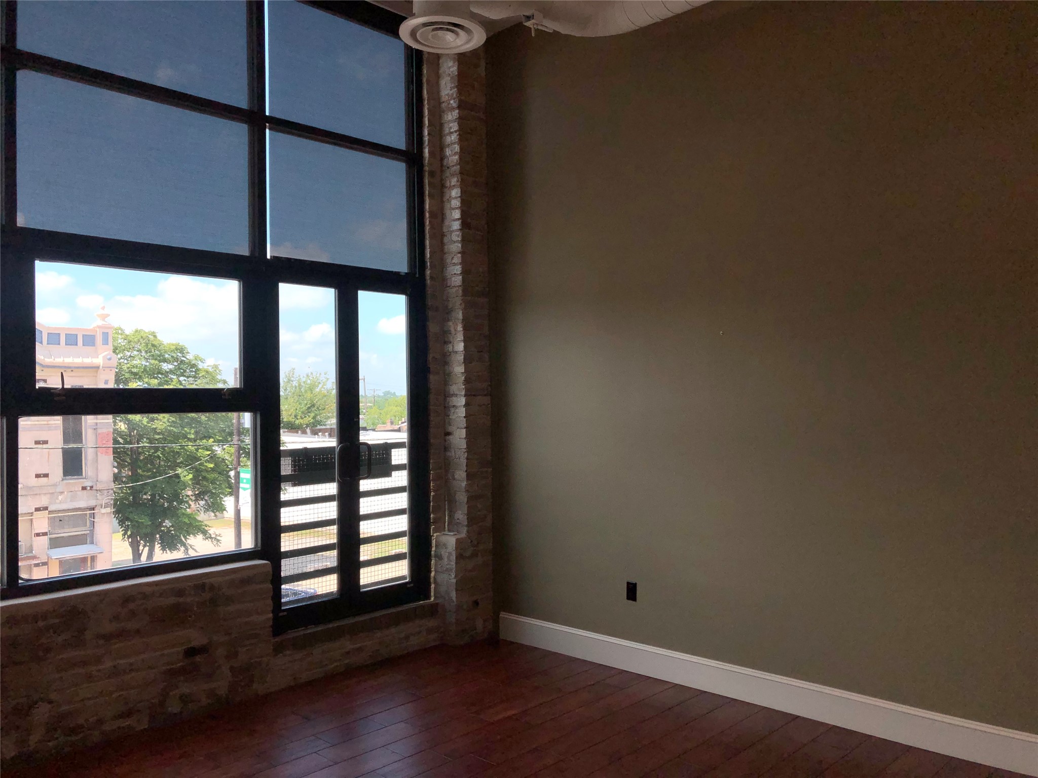110 West 2nd Street, Unit LOFT B Taylor, TX 76574 - Photo 7 of 11 a view of empty room with wooden floor and fan