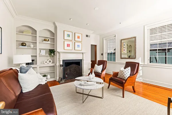 a living room with furniture fireplace and window