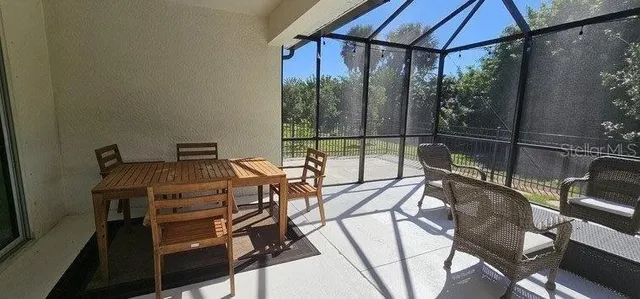 a view of a balcony with chairs and a stove