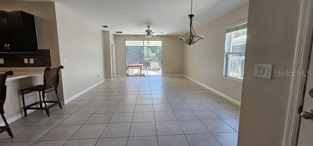 a view of an empty room with a fireplace and a window