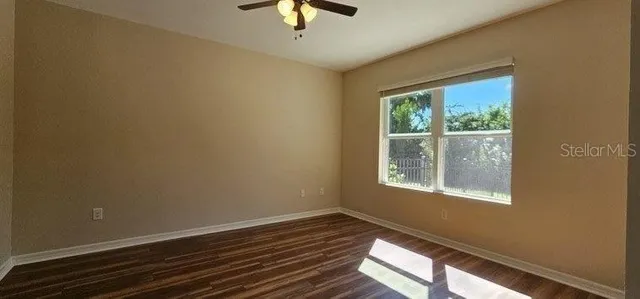 a view of room with window and ceiling fan