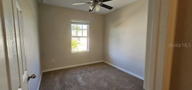 a front view of a house with a yard and potted plants