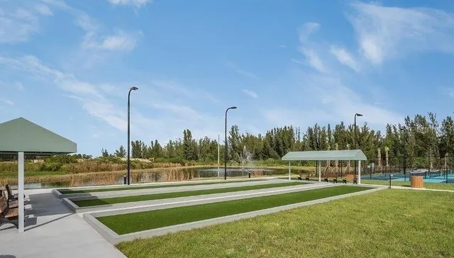 a view of a swimming pool and trees in the background