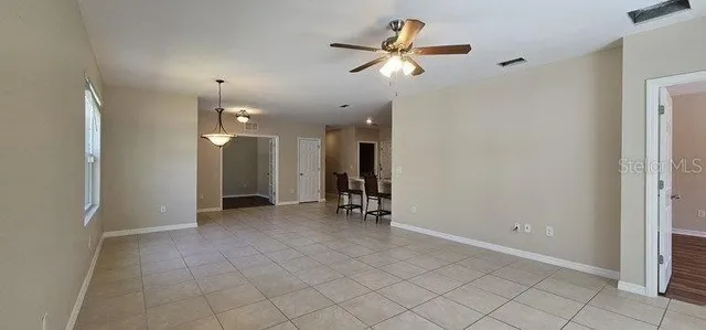 an empty room with fan and entrance
